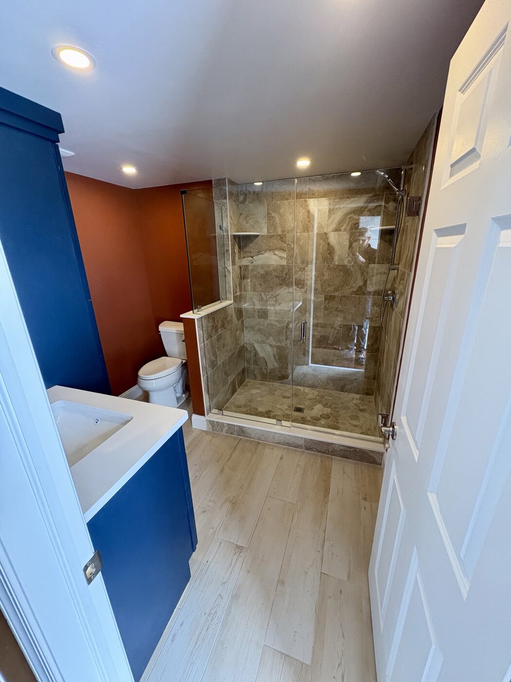 Completed Antler Drive bathroom in Glen Mills with custom glass shower and navy cabinetry