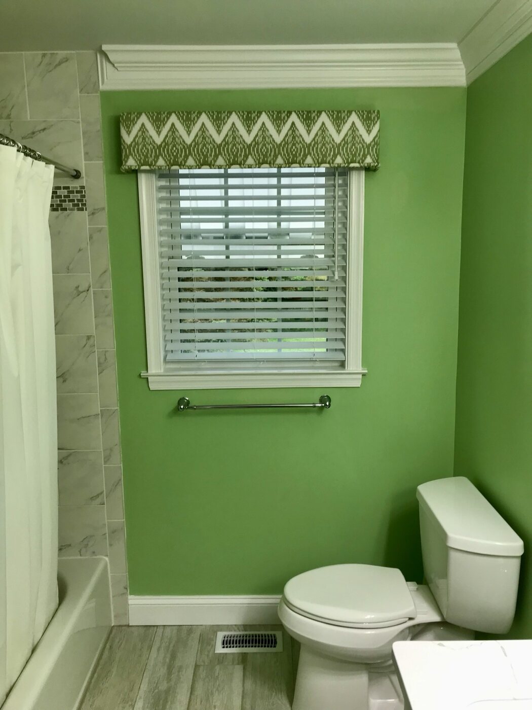 Bathroom 5 toilet, window trim, and tiled tub surround