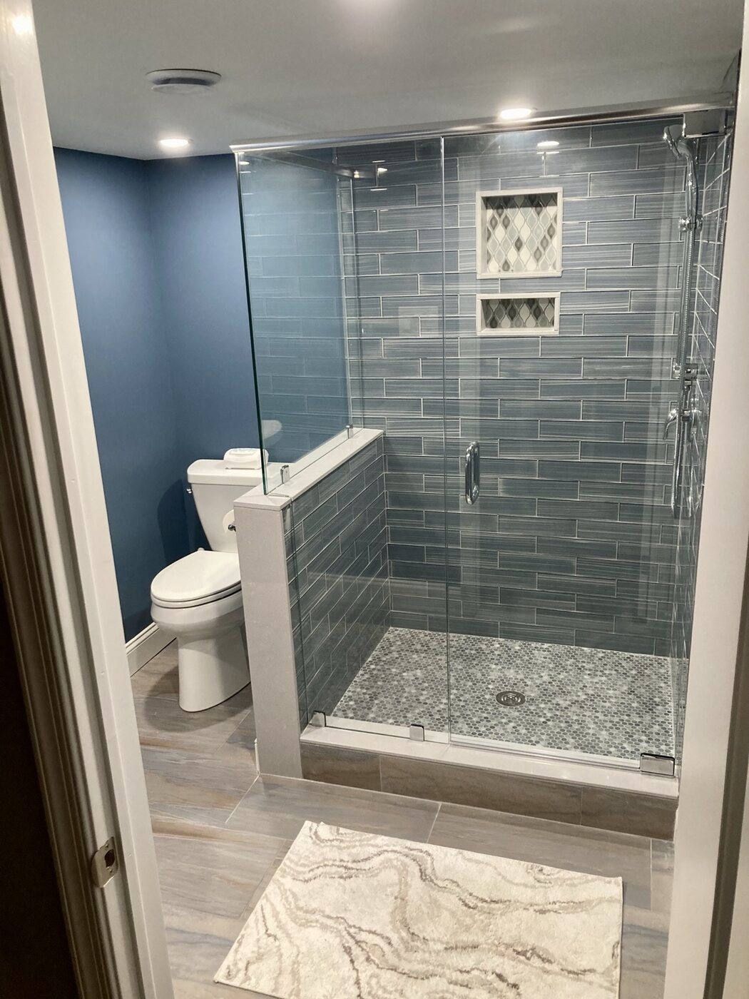 Bathroom 2 with blue tile walk-in shower and glass enclosure