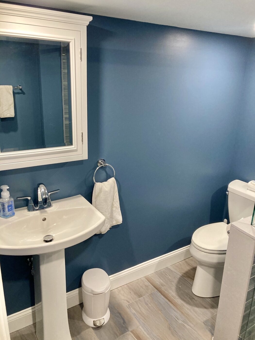 Bathroom 2 pedestal sink and blue accent wall