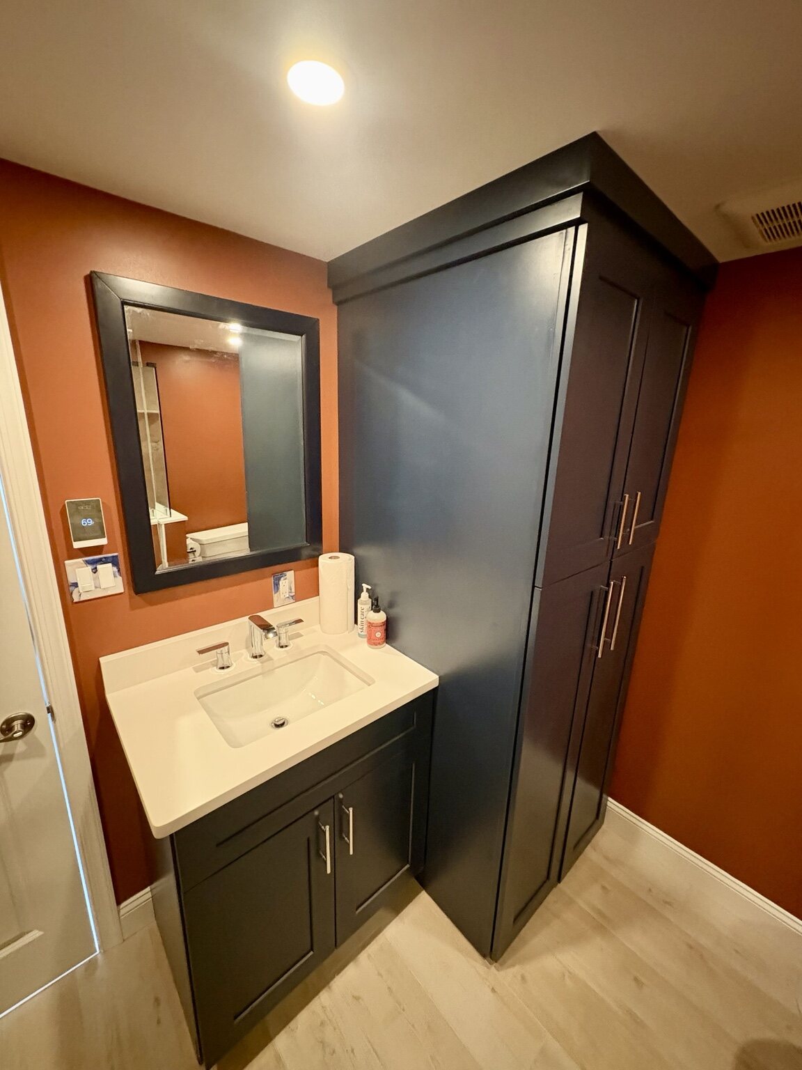 Bathroom vanity, mirror, and storage details
