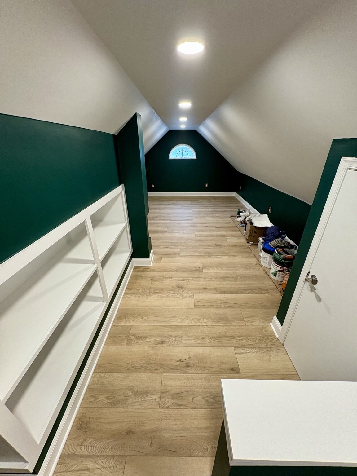 Finished bedroom with dark green walls and mini-split system