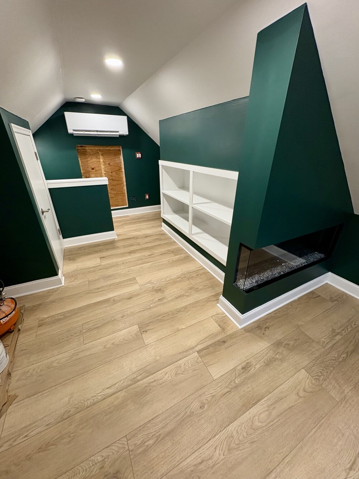 Finished bedroom and living space with built-ins and fireplace