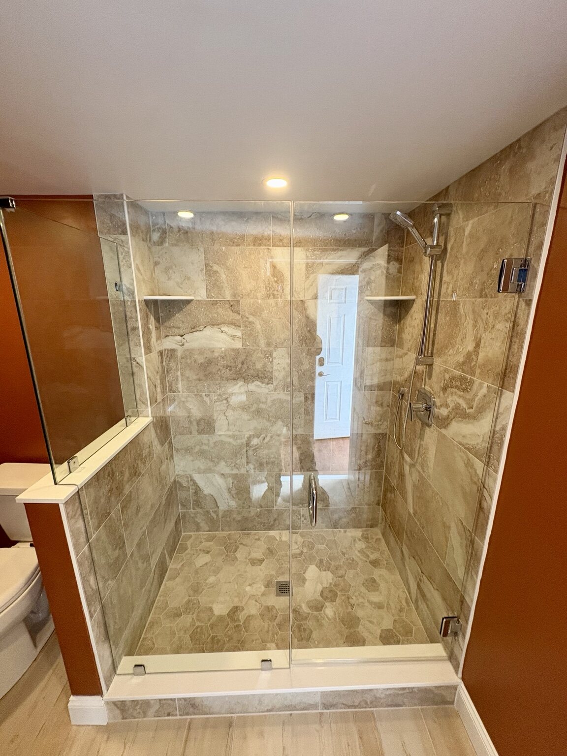 Custom tiled shower with glass enclosure
