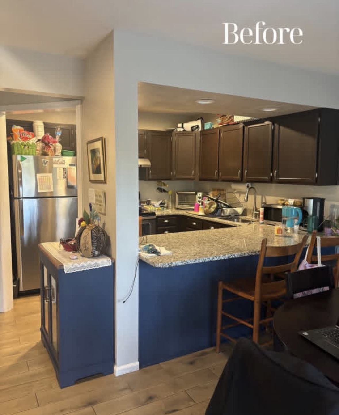 Kitchen before renovation, showing the original peninsula and dark cabinetry