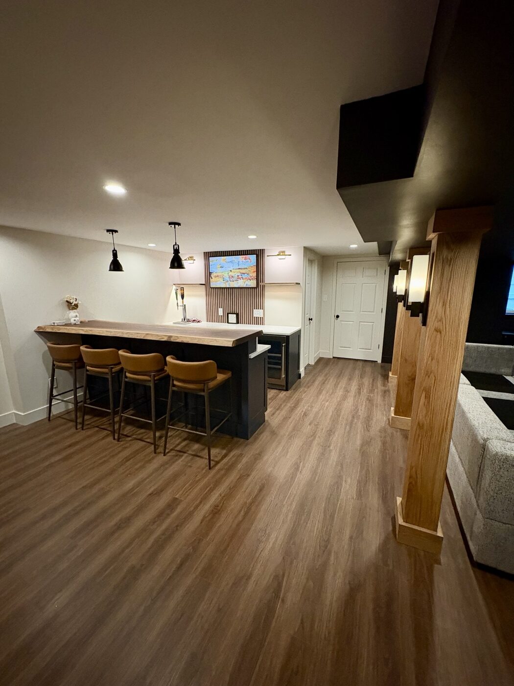 Finished bar and entertainment area with luxury vinyl plank flooring