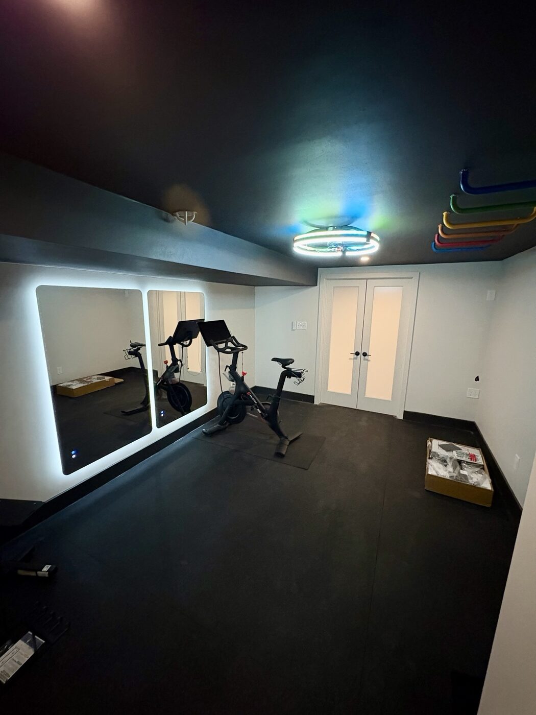 Finished basement home gym with exercise equipment and storage