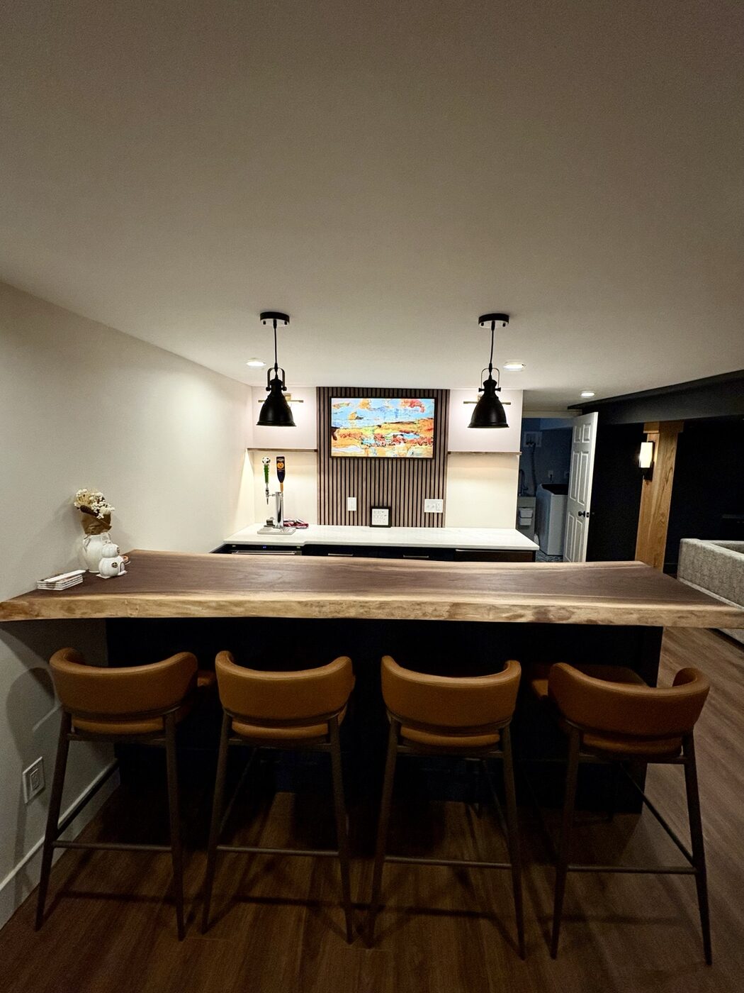 Custom live-edge basement bar with seating for four