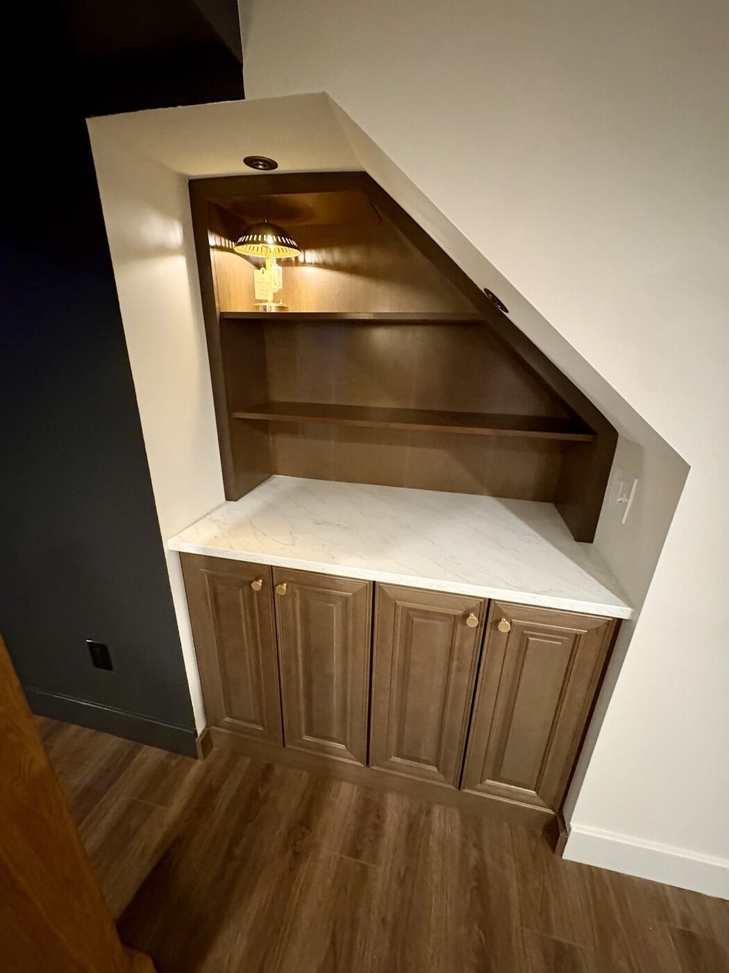 Custom under-stair built-in cabinetry with quartz counter and display shelves