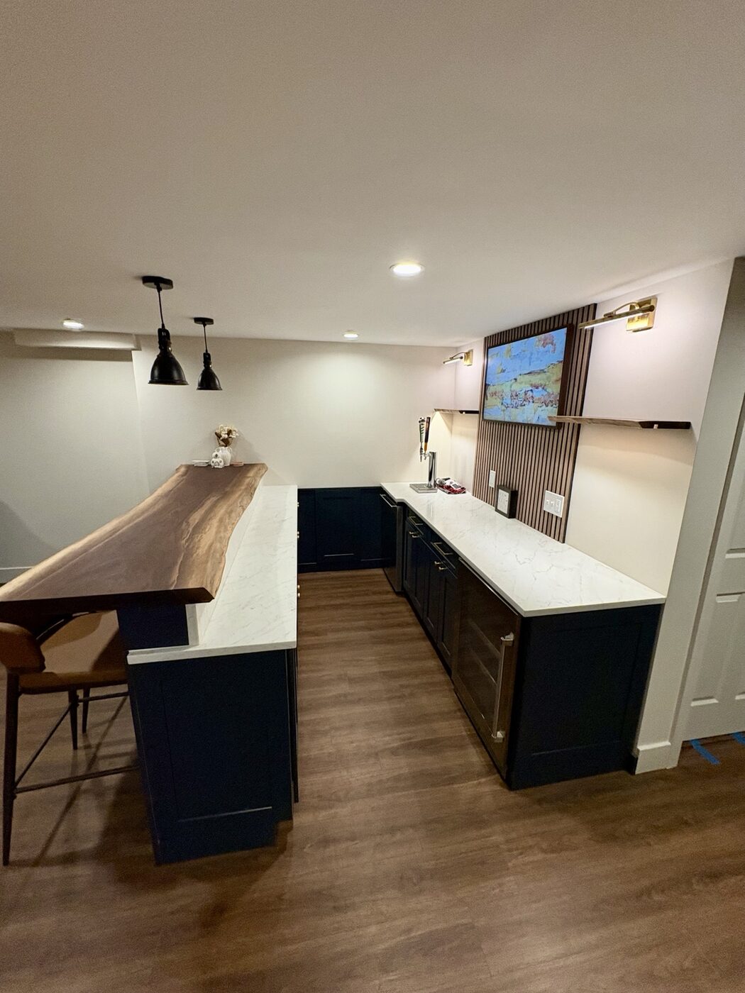 Custom wet bar cabinetry with quartz counters and beverage storage